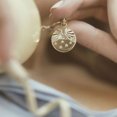 The Hand Engraved Diamond Universe Charm on a Baby Belcher